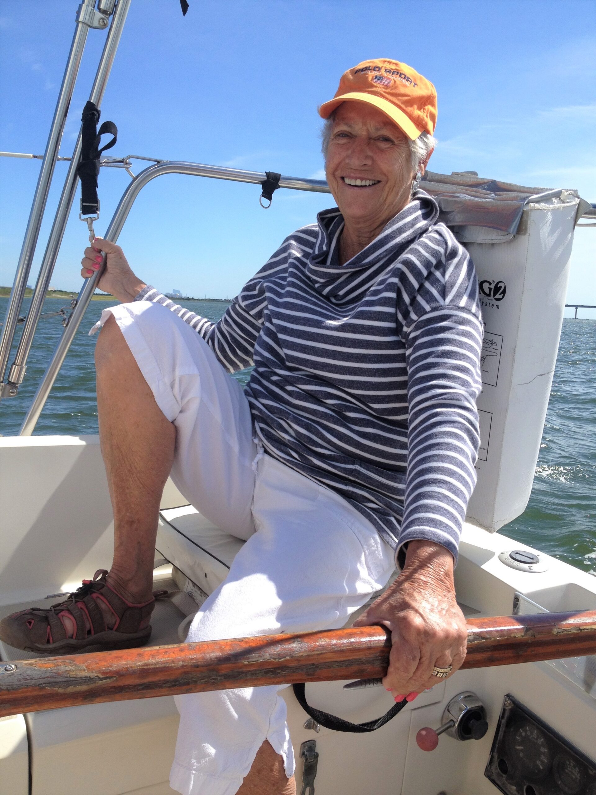 A woman sitting on the front of a boat.